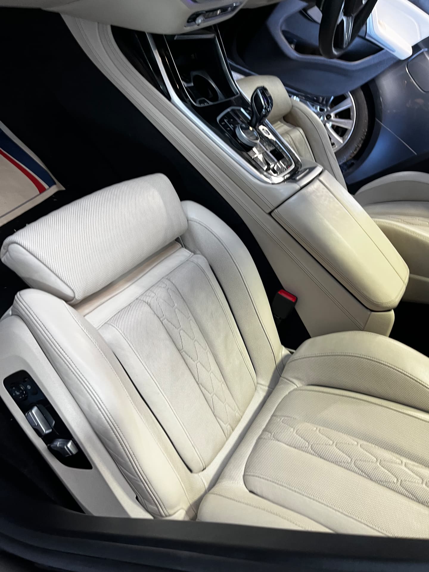 BMW light leather seat, headrest and centre armrest after restoration by PJ Leather Paint