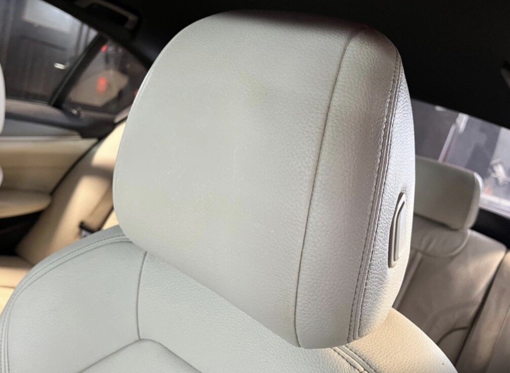 The same cream leather headrest after repair and recolouring by PJ Leather Paint