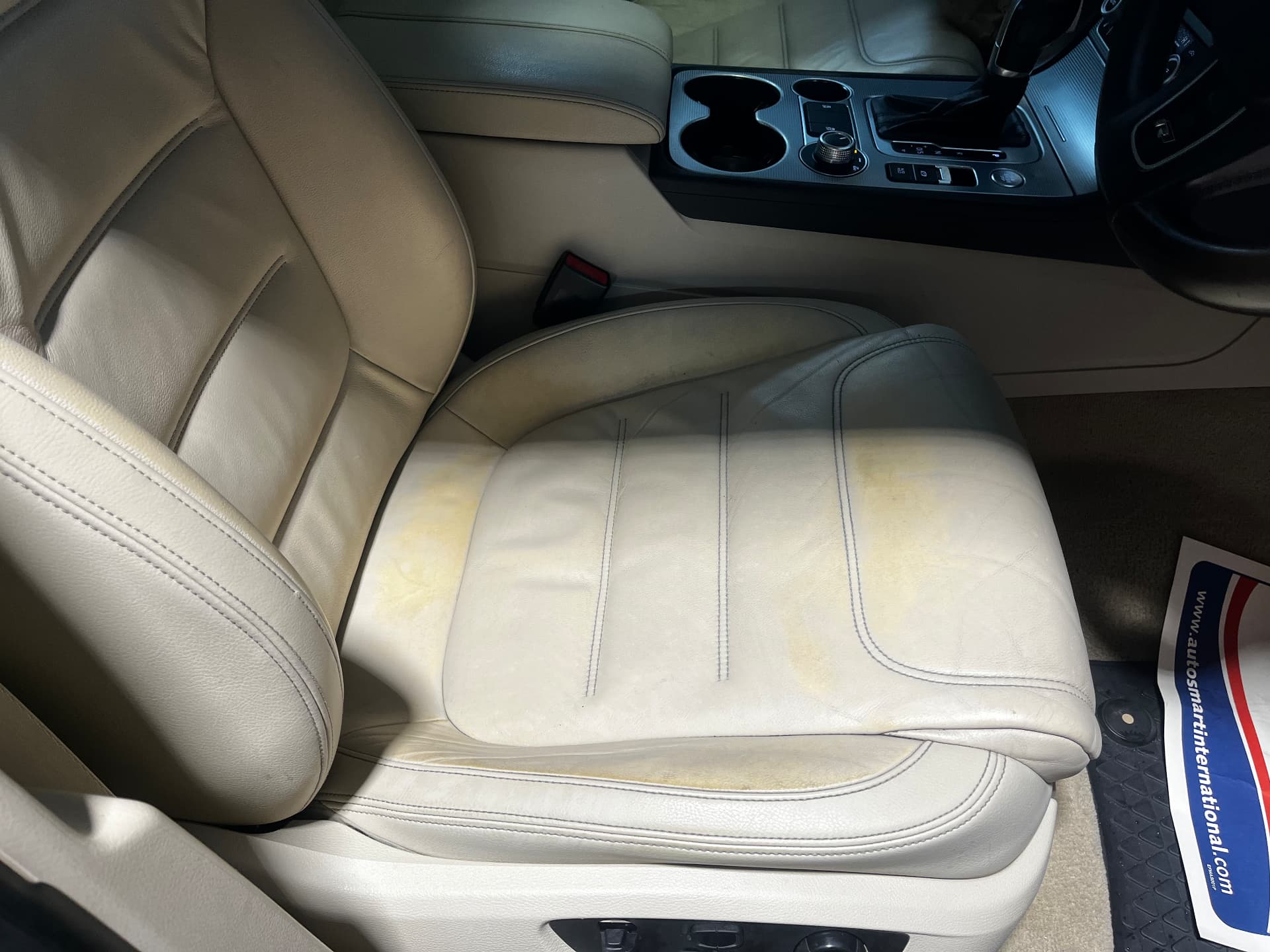 Discoloured and worn cream leather seat cushion before restoration by PJ Leather Paint