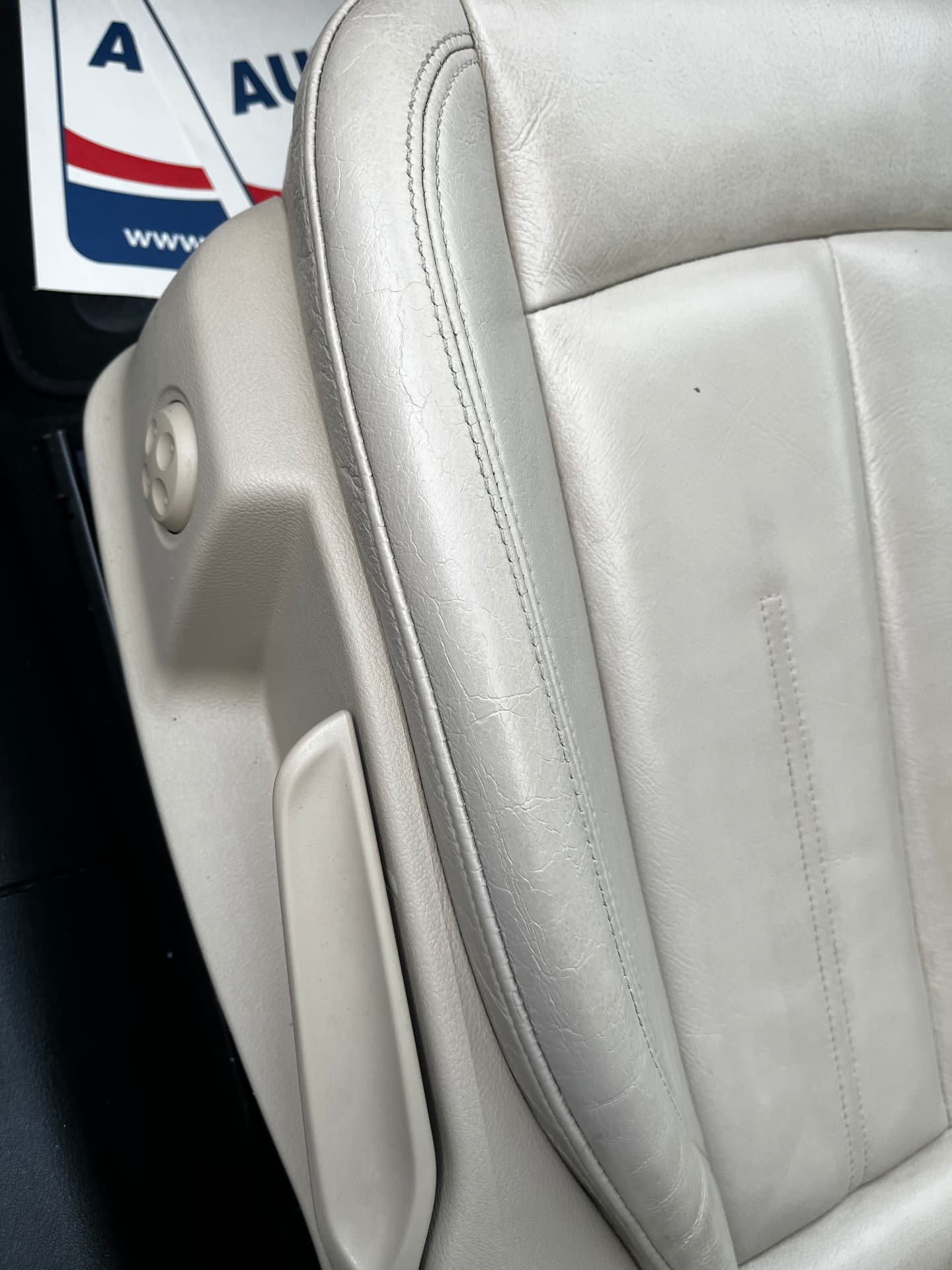 The same light leather car seat bolster after repair and colour restoration by PJ Leather Paint