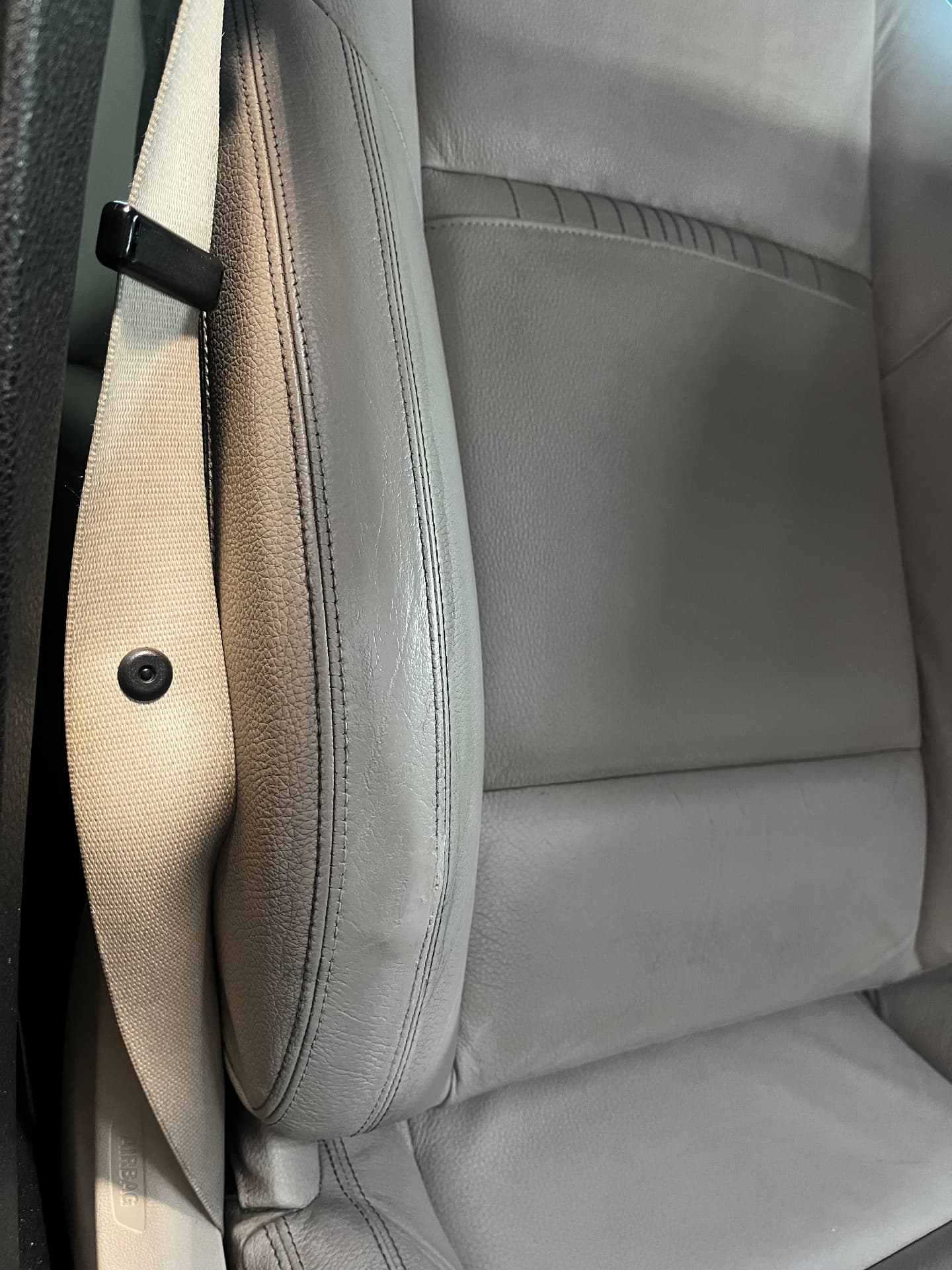 The same light leather seat bolster after hole repair and colour matching by PJ Leather Paint