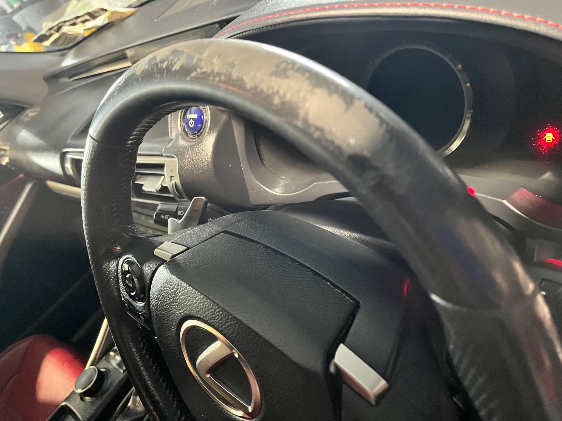 Heavily worn top rim of a Lexus leather steering wheel before restoration by PJ Leather Paint