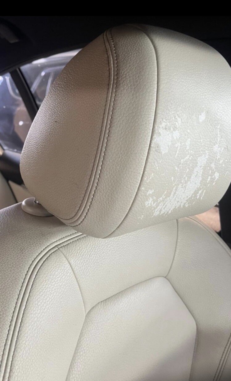 Worn, peeling cream leather headrest before restoration by PJ Leather Paint